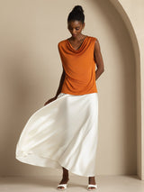 Women's orange sleeveless cowl neck silk top with white skirt