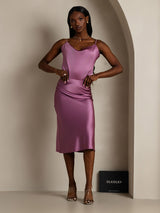 Model wearing a mauve silk cowl neck camisole dress with spaghetti straps