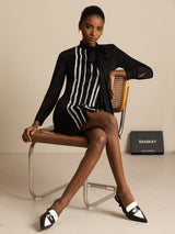 Black silk tie-neck shirt dress with vertical pleats and lace stripe front panel