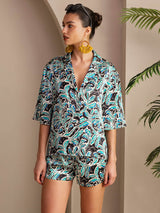 Women’s botanical print silk pajama set with short-sleeve button-up top and shorts
