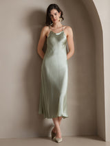 Model wearing light green silk spaghetti strap maxi dress