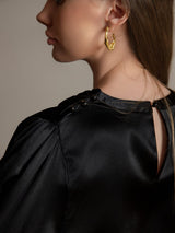 Black silk long sleeve boat neck blouse with pearl button details and open back