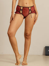 Sheer red silk cut out panty with black trim and side tie detail