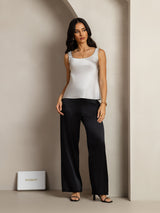 White 19Momme silk sleeveless U-neck tank top on model with black pants